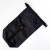 A black waxed cotton bicycle stuff sack with a rolled top, a daisy chain, and a metal quick-release buckle.